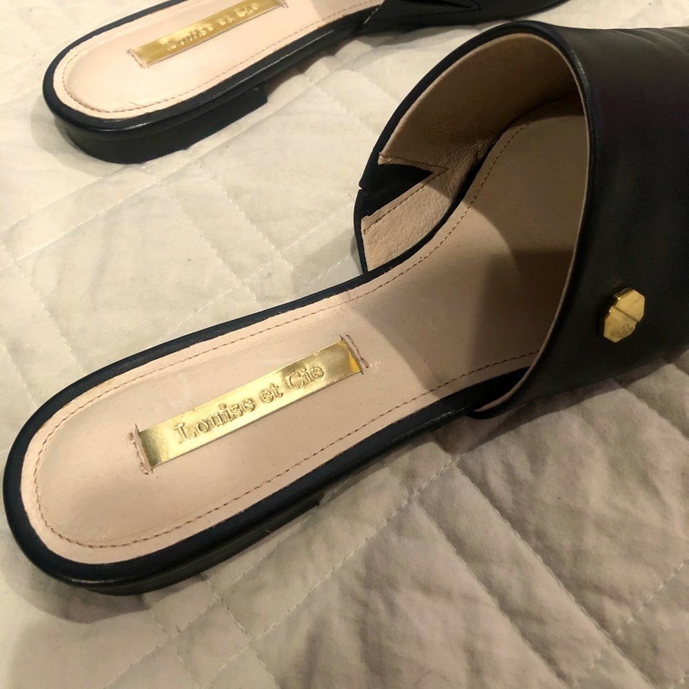 Black leather flats with gold detail